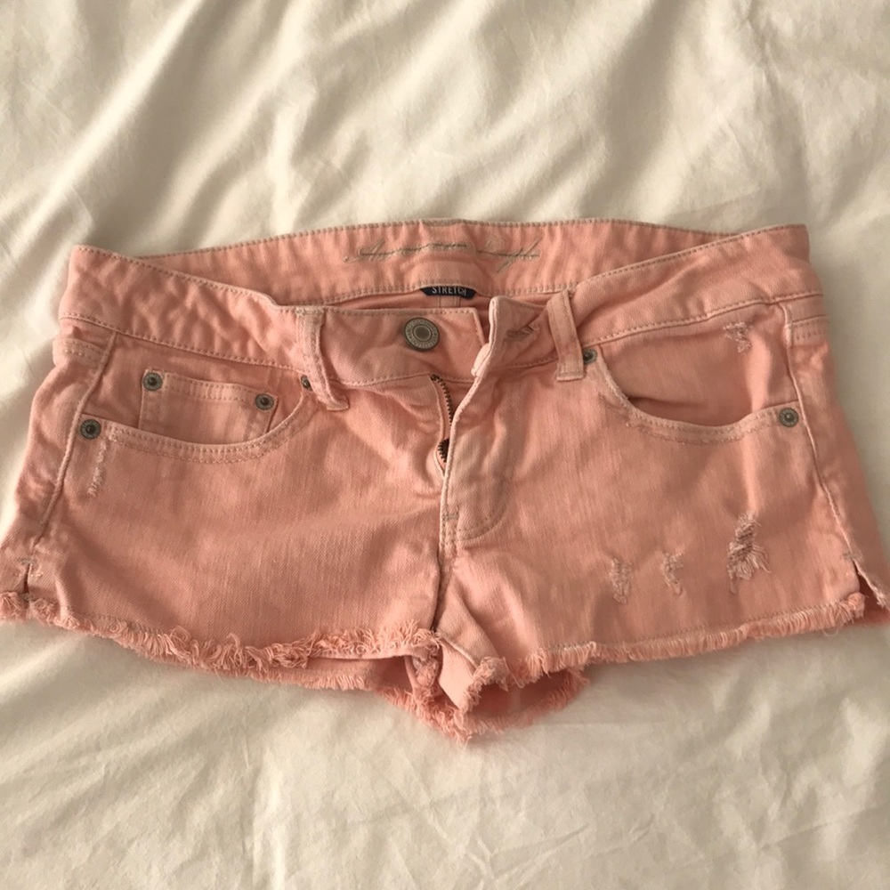 Peach distressed jean shorts